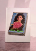 Cassette tape with a colorful cover featuring a woman and a flower on a white background